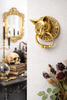 Gothic Victorian style wall scene featuring brass cat head ring pull hardware, ornate antique-inspired decor