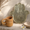 Close-up of Hamsa hand brass tray showing engraved eye and symbolic detail, used as a rolling tray, smoking tray, and spiritual decor piece