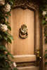 Hamsa hand door knocker installed on a wooden front door creating a unique entryway statement