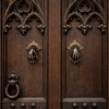 Brass hand door knockers on gothic style double doors, dramatic entryway door hardware, unique door accessories