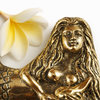 Close up of brass mermaid wall hook with detailed sculpted face for coastal decor