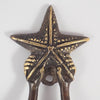 Close-up of starfish screw mount detail on mermaid brass door handle, coastal door hardware