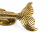 Close-up of mermaid tail detail on solid brass door handle