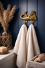 Brass mermaid double hook used as towel holder in coastal bathroom beach house decor