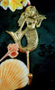 Gold mermaid brooch with shells and flowers on a dark background