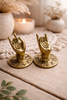 Mini brass Buddha hand cabinet pulls bundle styled on tabletop, gold finish mudra handles that also work as jewelry holder hooks.