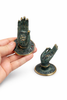 Patina finish mini Buddha hand cabinet pull shown in hand for scale, handmade brass mudra hardware from Bali