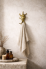 Minimal coastal wall decor with brass sea shell hook towel holder neutral bathroom styling