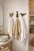 Nautical bathroom with brass sea life hooks whale and seal used as towel hangers coastal decor