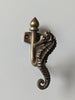 Angled view of brass seahorse wall hook showing sculptural detail for coastal and nautical home decor