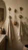 Nautical brass seashell wall hooks used as towel hangers in coastal bathroom