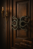 Large octopus tentacle door pull installed on a dark wood door for a gothic look