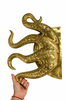 Hand holding large octopus tentacle door pull (single) showing curved tentacles and texture