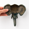 Back view of patina brass elephant wall hook showing two mounting holes and solid brass construction for easy wall installation. Decorative coat hook and towel hook from set of 4 for boho home decor, wabi sabi decor, yoga room decor and meditation space decor. Unique boho housewarming gift and eclectic gallery wall hook set of 4 with no tariffs for US buyers