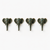 Flat lay of complete set of 4 patina brass elephant wall hooks arranged in a row on white background showing all hooks together with consistent verdigris patina finish, golden tusk detail and warm gold ear accents on each piece. Handcrafted boho gallery wall hook set, wabi sabi home decor, yoga room decor, meditation space decor and unique boho eclectic housewarming gift set of 4