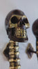 Video close-up of skull spine door handle pair showing skull detail and finish texture