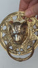 Video of the brass cat head towel ring held in a hand and turned to show the sculpted cat face, ornate scrollwork plate and solid brass ring. Handmade gothic door knocker and drawer pull from Ubud, Bali.