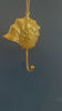 Video showing brass seashell wall hook with spiral web design hanging against a dark blue wall, nautical coastal coat hook
