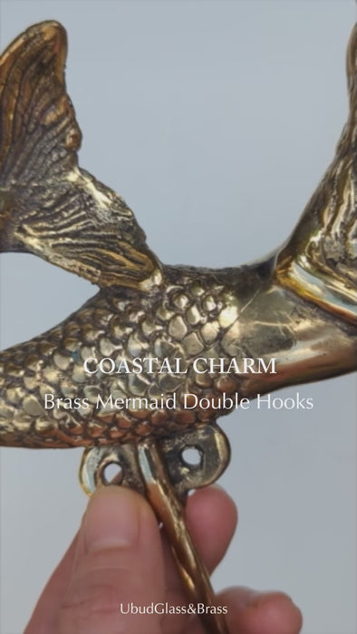 Close view of brass mermaid double wall hook showing detail and coastal nautical design