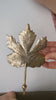 Video showing hand mounting a brass maple leaf wall hook
