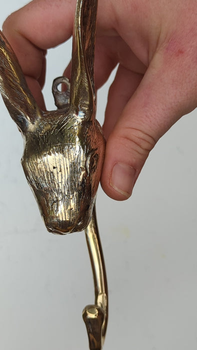 Close-up video of handcrafted brass rabbit wall hook, bunny wall hook for cottagecore decor, whimsical nursery wall decor, Peter Rabbit inspired brass animal hook