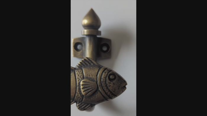 Video showing handmade brass fish wall hook with nautical coastal design and texture detail