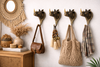 Four rhino wall hooks mounted in an entryway with bags and towels, safari boho wall storage