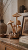 Rustic wooden mushroom decor styled in home interior, handcrafted wood mushroom sculpture cottagecore aesthetic