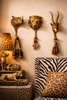 Brass animal wall hook set in safari themed interior with lion rhino and impala decor