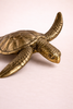 Close up of brass sea turtle sculpture tail and shell detail handmade in Bali