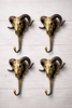 Set of 4 brass ram skull wall hooks bundle on light wood background for gothic dark academia entryway organization