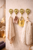 Set of 4 brass sun moon wall hooks in nursery holding baby items, celestial nursery wall hooks