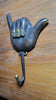 Antique shaka wall hook mounted on wooden wall coastal decor hook