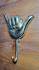 Gold brass shaka wall hook mounted on wooden surface towel hook decor