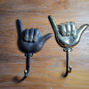 Gold and antique brass shaka wall hooks side by side comparison finishes