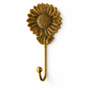 Single brass sunflower hook on a clean background, floral wall hanger for towels, robes, or keys.