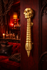 Skull spine door handle styled in a moody room for gothic dark academia decor aesthetic