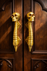 Skull spine door handle pair styled on arched doors for gothic dark academia entry decor