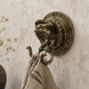 Solid brass eagle snake wall hook styled in a wabi sabi interior, used as towel hook, gothic decor and dark academia wall hook, antique brass double hook, unique housewarming gift, statement wall hardware for bathroom or entryway
