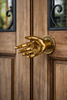 Solid brass handshake door pull installed on double entry doors
