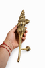 Hand holding solid brass seashell door handle showing size and craftsmanship coastal nautical hardware