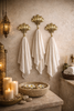 Antique brass seashell wall hooks in spa style bathroom decor