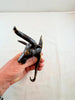 Hand holding Texas longhorn brass wall hook to show size and strength, heavy-duty western coat hook hardware