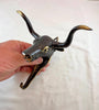 Side angle of Texas longhorn brass wall hook showing depth from wall, sturdy western towel hook and coat hanger.