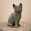 Vintage style brass cat figurine photographed in warm light, sculptural home decor accent