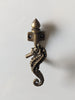 Detailed view of brass seahorse wall hook with vintage finish for beach house and ocean decor