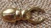 Solid brass scarab beetle bottle opener on wooden surface, gift for beer lovers