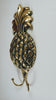 Decorative Large Gold Brass Pineapple double hook on white wall from the side