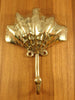 Aged antique brass shell wall hook patina detail