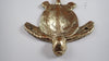 Antique finish brass sea turtle wall hook showing the darker patina, handcrafted nautical coastal wall decor option.